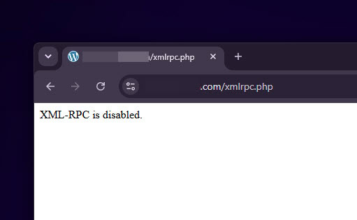 The browser window accessing the WordPress website's xmlrpc.php file displays a blank white page with the short message "XML-RPC is disabled," confirming that the disabling was successful.