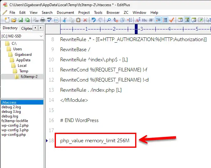 A code editor displaying the .htaccess file with a red arrow pointing to the php_value memory_limit 256M directive used to fix WordPress memory errors.
