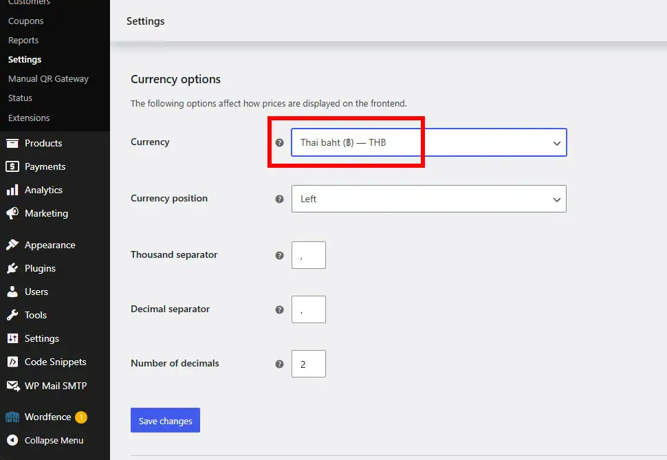 A screenshot of the WooCommerce Settings page focusing on the Currency options section. A red rectangular box highlights the Currency dropdown menu, which is currently set to Thai baht (THB). This step demonstrates how to configure the correct local currency required for the PromptPay QR payment gateway to function properly.